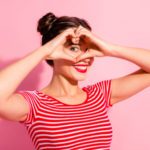 lady pretty two buns pomade lips hold hands arms heart shape figure near eye